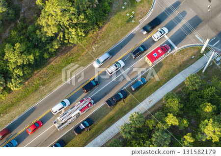 Car accident on highway road in Florida. Emergency services personnel helping victims of vehicle crash on city street in USA Car accident on highway road in Florida. Emergency services personnel helping victims of vehicle crash on city street in USA 131582179