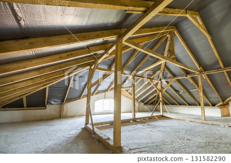 Attic of a building with wooden beams of a roof structure. 131582290