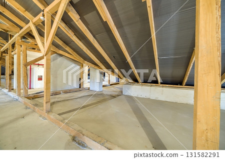 Attic of a building with wooden beams of a roof structure. 131582291