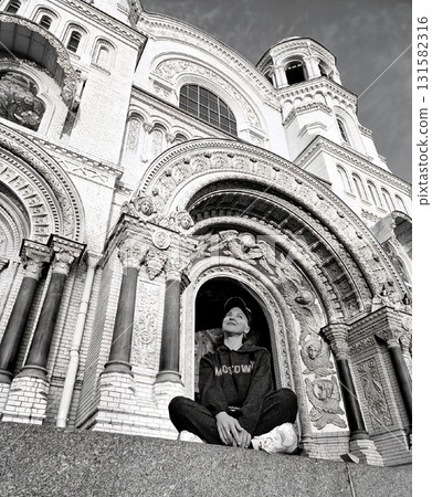 Woman Sits Before Grand Cathedral Archway Woman Sits Before Grand Cathedral Archway 131582316