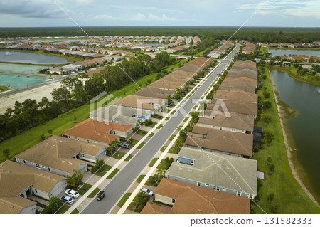 Aerial view of tightly located family houses in Florida closed suburban area. Real estate development in american suburbs Aerial view of tightly located family houses in Florida closed suburban area. Real estate development in american suburbs 131582333