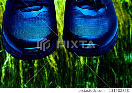 Walking hiking.Trekking shoes under green grass Walking hiking.Trekking shoes under green grass 131582828