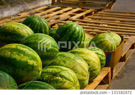 Pile of ripe sweet watermelons at the market pallets 131582872