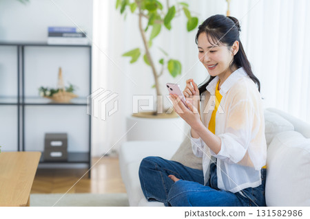 A woman who operates a smartphone in the room A woman who operates a smartphone in the room 131582986