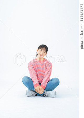 Full-body photo of a teenage girl wearing casual clothing sitting Full-body photo of a teenage girl wearing casual clothing sitting 131583171