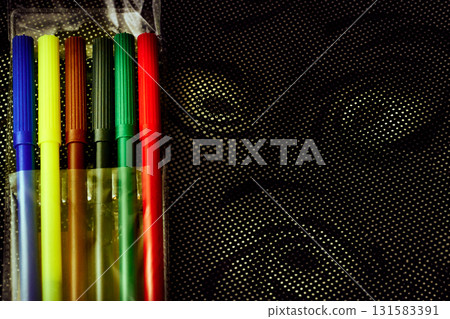 Set of multicolored felt tip pens markers for drawing on dark spotted fabric 131583391