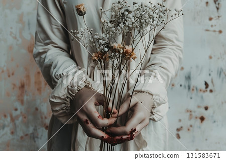 Ink-Stained Fingers Clutching Fragile Dried Flowers 131583671