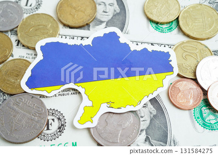 Ukraine flag on coin and banknote money, finance trading investment business currency concept. Ukraine flag on coin and banknote money, finance trading investment business currency concept. 131584275