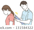 A young female patient receiving treatment from a male chiropractor 131584322