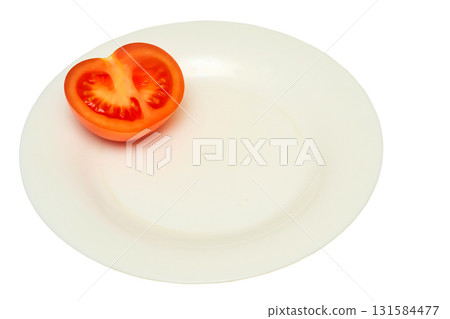 Half of a cut ripe tomato on a white plate. Ready to eat 131584477