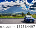 A blue car parked in a parking lot at the foot of Mount Yotei, Hokkaido. Autumn, October. 131584497