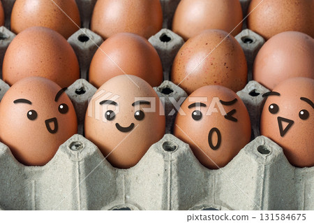 Close up view of organic fresh chicken eggs in paper cardboard tray packaging with various happy faces. 131584675