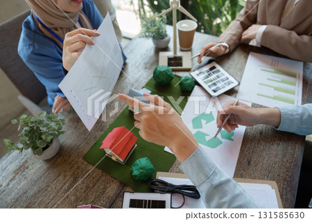 Sustainable Business Strategies and Collaboration. Professionals discuss green initiatives in a team meeting focused on eco-friendly practices. 131585630