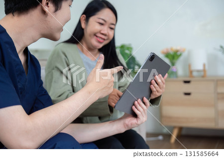 Healthcare Trust and Patient Engagement. A nurse enthusiastically shares health updates using a tablet, highlighting patient involvement. Healthcare Trust and Patient Engagement. A nurse enthusiastically shares health updates using a tablet, highlighting patient involvement. 131585664