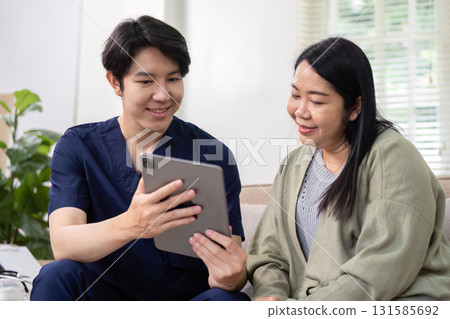 Healthcare and Technology Use. A healthcare professional demonstrates digital tools to enhance patient engagement and education. Healthcare and Technology Use. A healthcare professional demonstrates digital tools to enhance patient engagement and education. 131585692