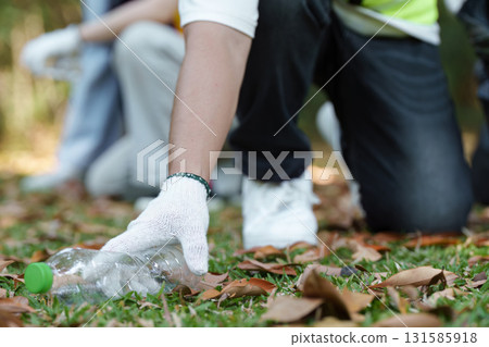 Community Cleanup Effort. A conscientious volunteer picks up plastic waste to promote sustainability. Community Cleanup Effort. A conscientious volunteer picks up plastic waste to promote sustainability. 131585918