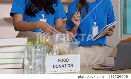 Volunteers Organizing Food Donations. Community members working together for a cause. 131586096