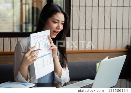 Business professional discussing budget analysis via video call, showcasing financial insights. 131586134