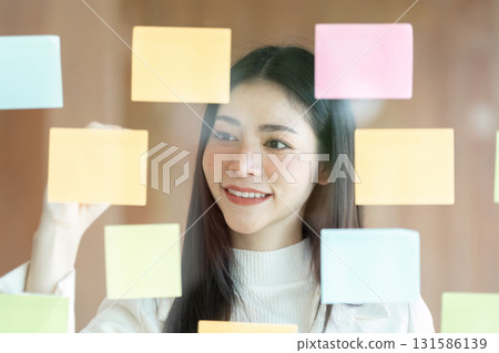 Business professional focused on sticky note organization for effective collaboration 131586139