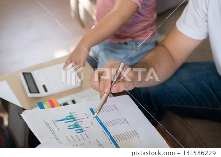 Mother working from home while caring for her child, managing finances and balancing family life. Mother working from home while caring for her child, managing finances and balancing family life. 131586229