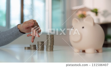 Money Management. Woman counting coins at home office. 131586407