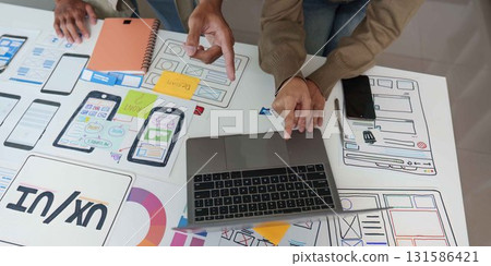 Collaborative UX UI Design Session with Laptop and Sketches 131586421