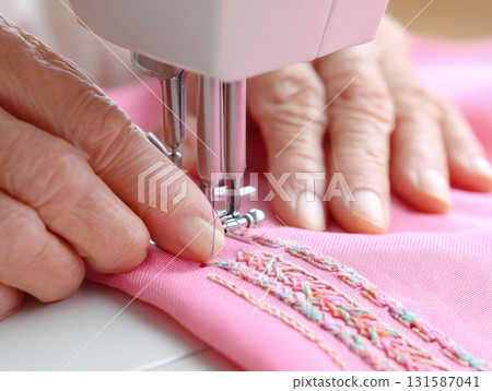 Elderly hand sewing pink fabric with embroidery using sewing machine, demonstrating skill, patience, and longevity in textile craft, close up detail, calm atmosphere Elderly hand sewing pink fabric with embroidery using sewing machine, demonstrating skill, patience, and longevity in textile craft, close up detail, calm atmosphere 131587041