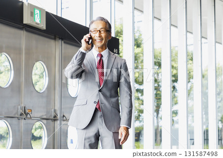Businessmen talking on smartphone 131587498