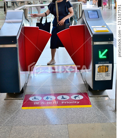 A woman passing through the ticket gate 131587591