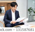 A Japanese businessman in his 40s checking documents before a meeting in the lobby 131587681