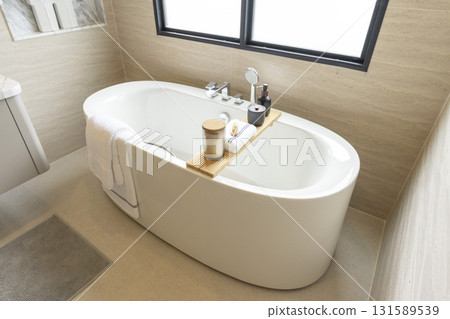 white freestanding tub in new luxury home bathroom. 131589539