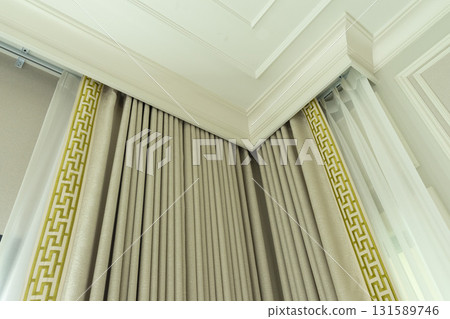 Close up of a curtain with gold trimmings in a luxury mansion. 131589746