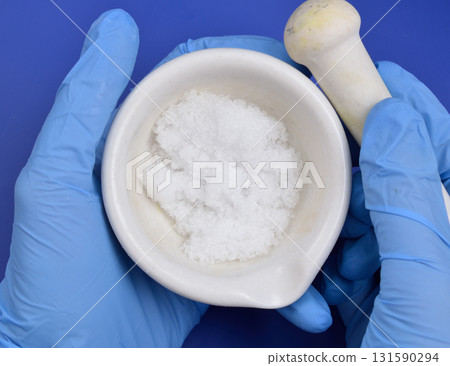 Magnesium nitrate powder on light grey background. 131590294
