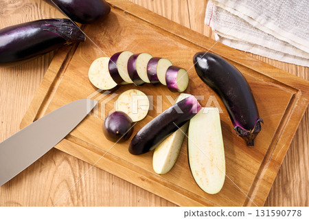 Eggplant cut on a cutting board | Image of preparation and cooking process Eggplant cut on a cutting board | Image of preparation and cooking process 131590778