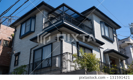 The exterior of the solar home features pale brick and a black frame. 131591421