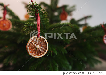 Closeup small christmas tree with natural decorations indoor Closeup small christmas tree with natural decorations indoor 131592779