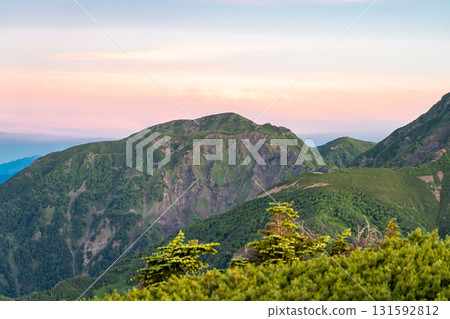 View of Mt. Usagi during the magic hour from the summit of Mt. Minami in the Southern Alps. Climbing Mt. Hijiri in the Southern Alps View of Mt. Usagi during the magic hour from the summit of Mt. Minami in the Southern Alps. Climbing Mt. Hijiri in the Southern Alps 131592812