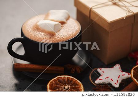 Hot chocolate in a black cup with christmas decorations Hot chocolate in a black cup with christmas decorations 131592826