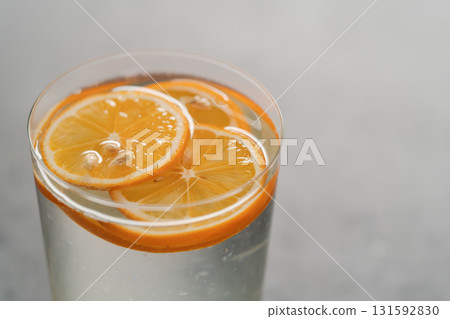 organic lemonade in tumbler glass on concrete background organic lemonade in tumbler glass on concrete background 131592830