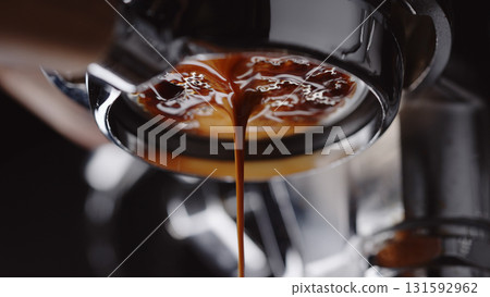 pull espresso shot with bottomless portafilter on a professional coffee machine 131592962