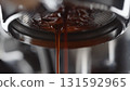 pull espresso shot with bottomless portafilter on a professional coffee machine 131592965