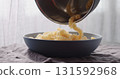 pour freshly cooked fusilli pasta in blue bowl 131592968