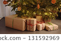 christmas gifts under spruce indoor with warm light 131592969