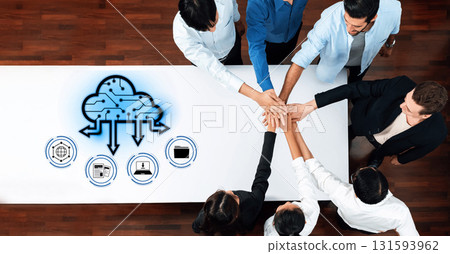 Team Collaboration in Innovative Cloud Computing Solutions with Hands Together on Table in Modern Workspace with Digital Icons Representing Technology Trope 131593962