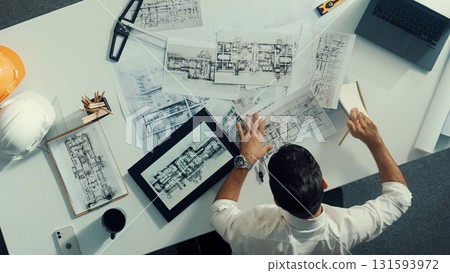 Top view of skilled engineer selecting material for house design. Alimentation. 131593972