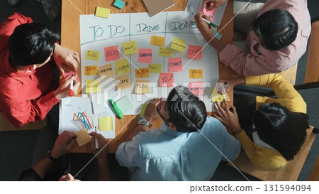 Top view of diverse people writing and making scrum task board. Convocation. 131594094