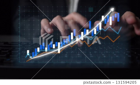 Businessman Analyzing Data Trends on a Modern Digital Graph with Hands on Keyboard in a Dark Office Setting Copula 131594205