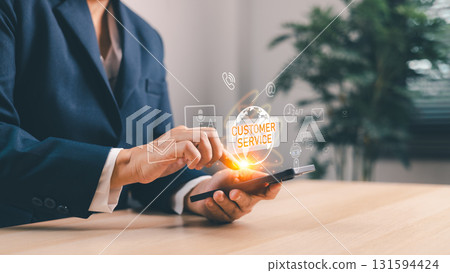 Business professional using smartphone with hologram customer service icon, futuristic digital support, online communication, AI technology, virtual assistant, corporate innovation concept. 131594424