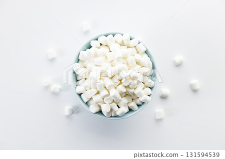 small marshmallows in a bowl on white table background. small marshmallows in a bowl on white table background. 131594539