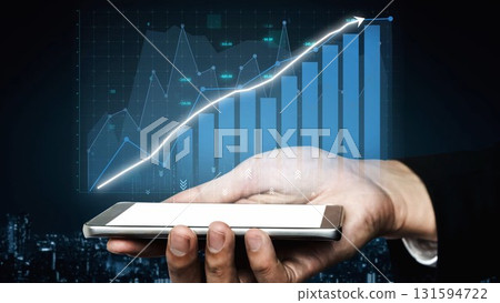 Hand holding smartphone with financial growth chart and data visualization in the background, symbolizing investment, technology, and business strategy. Copula 131594722